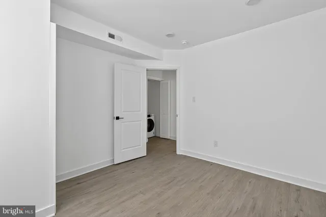 a view of an empty room with wooden floor