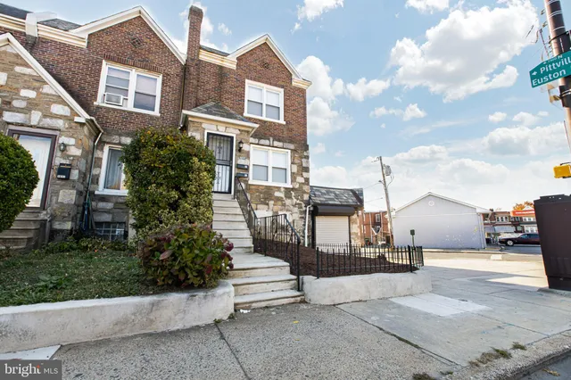 a view of a brick building next to a yard
