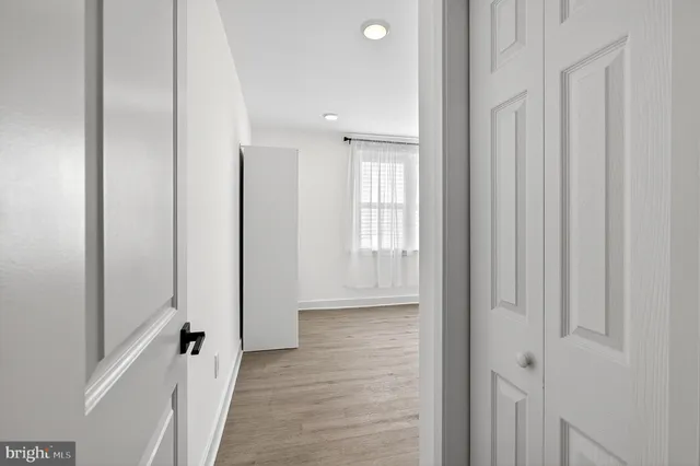 a view of a hallway with a wooden door