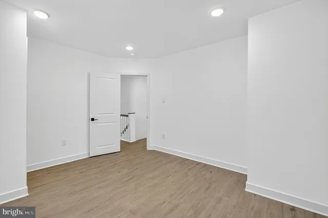 an empty room with wooden floor