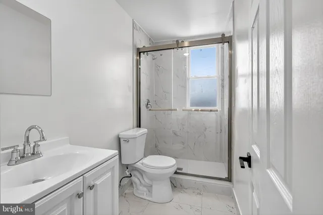 a bathroom with a toilet sink and shower
