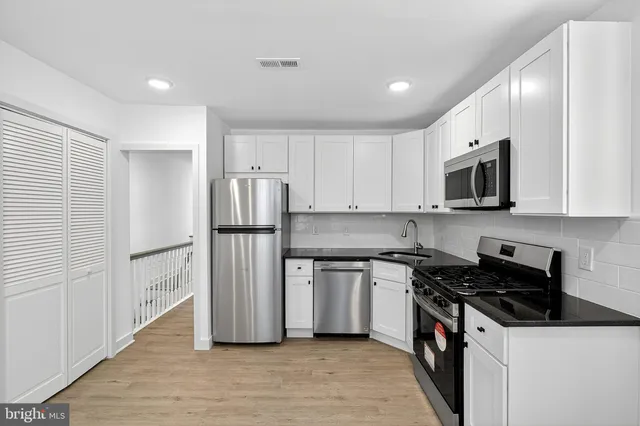 a kitchen with stainless steel appliances a refrigerator stove and microwave