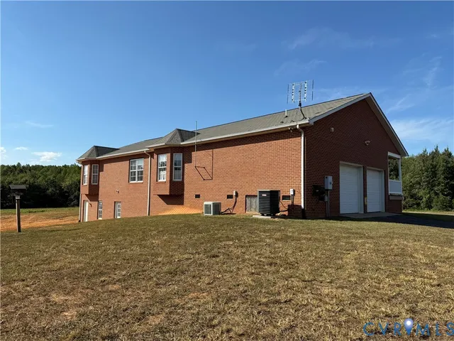 a view of a house with a big yard and a large tree