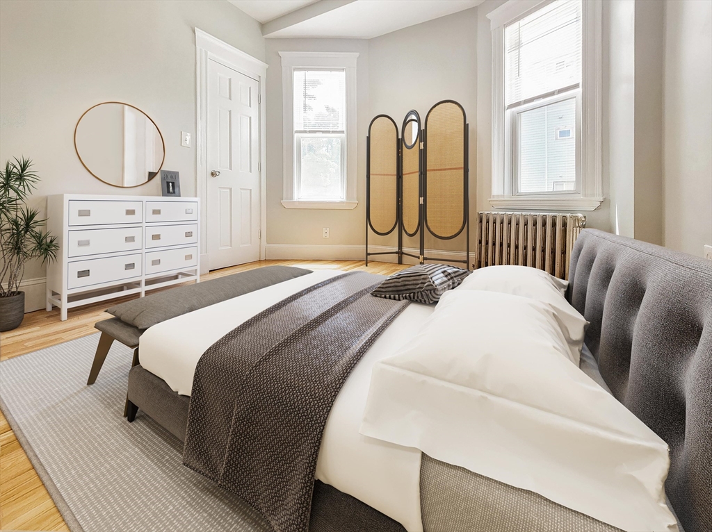 35 Dunlap Street, Unit 1 Boston, MA 02124 - Photo 5 of 7 a bedroom with a bed and windows