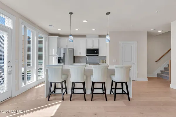 a view of kitchen with dining room and wooden floor