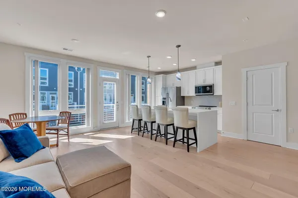 a open kitchen with stainless steel appliances granite countertop a sink a oven and a refrigerator