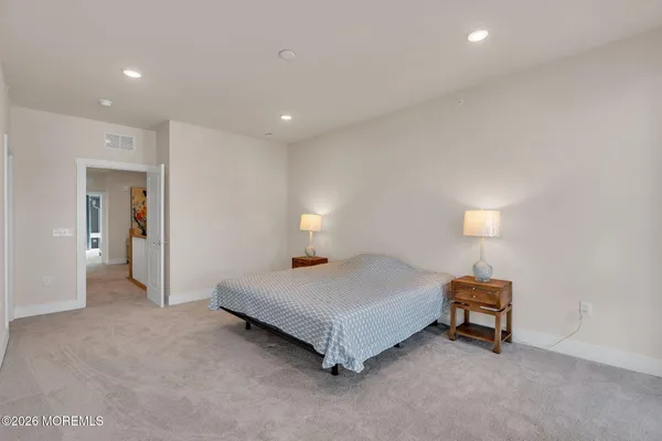 a bedroom with a bed and a lamp on table