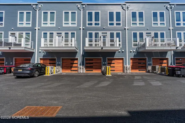 a view of a building with many windows and sitting area