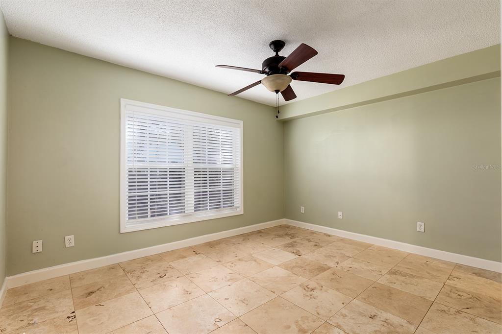 4822 South Conway Road, Unit 127 Orlando, FL 32812 - Photo 11 of 15 a view of an empty room with a window and a ceiling fan