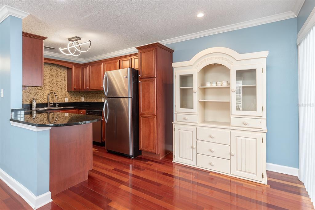 4822 South Conway Road, Unit 127 Orlando, FL 32812 - Photo 5 of 15 a kitchen with stainless steel appliances granite countertop a stove a refrigerator and a cabinets