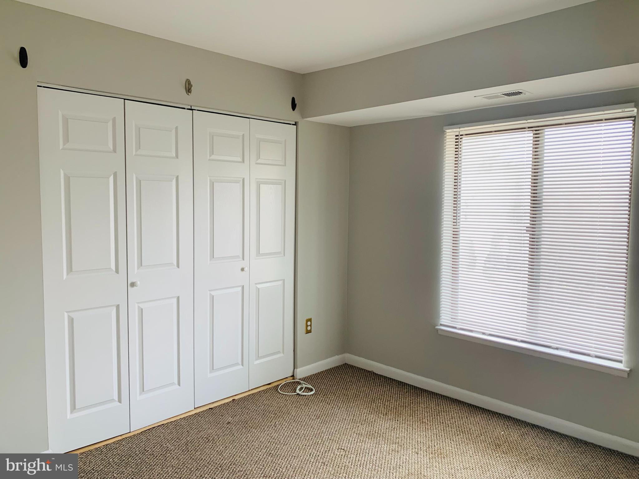 8875 Tamebird Court, Unit J Columbia, MD 21045 - Photo 11 of 15 a view of an empty room with a window
