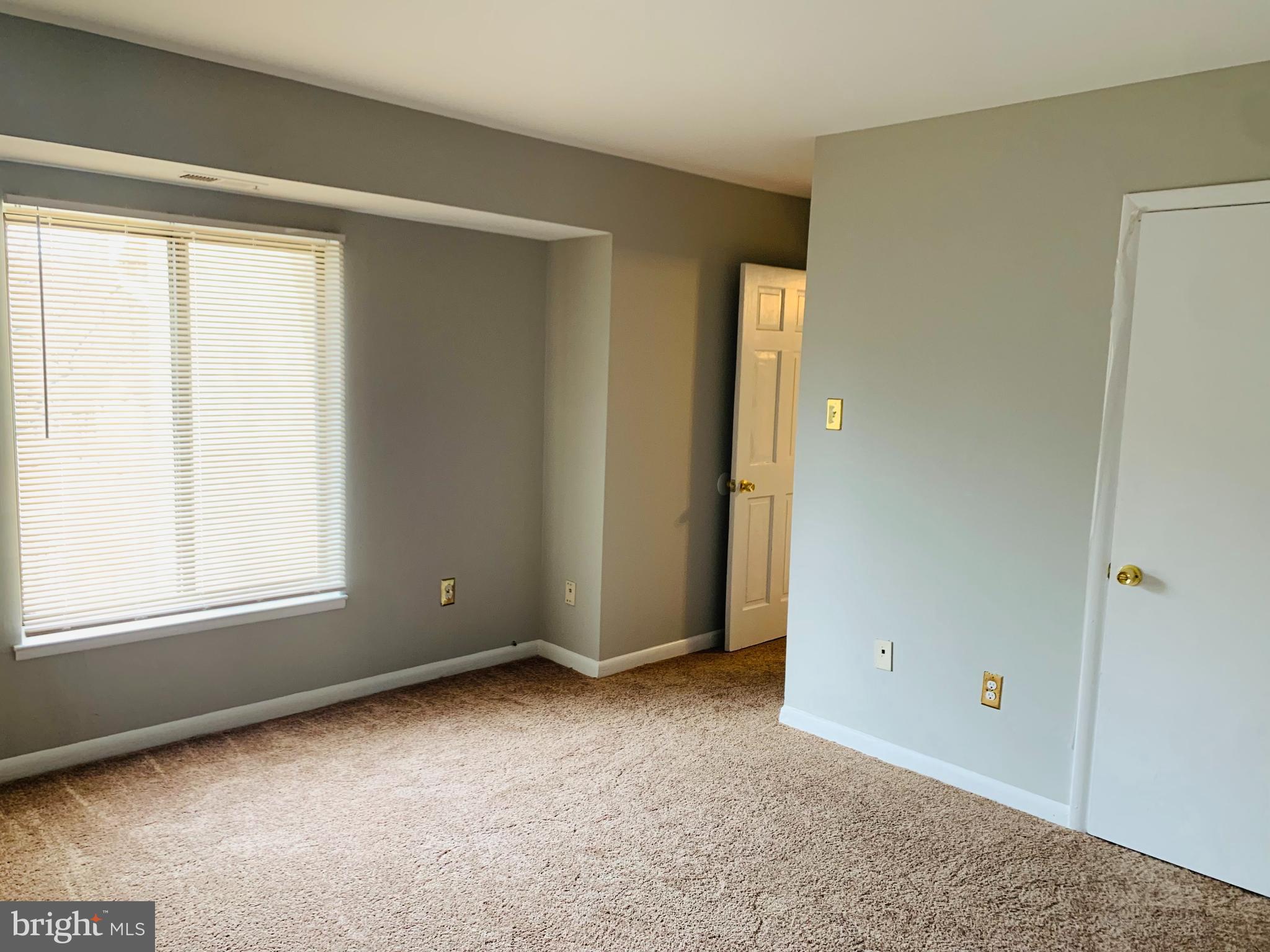 8875 Tamebird Court, Unit J Columbia, MD 21045 - Photo 12 of 15 a view of an empty room with a window