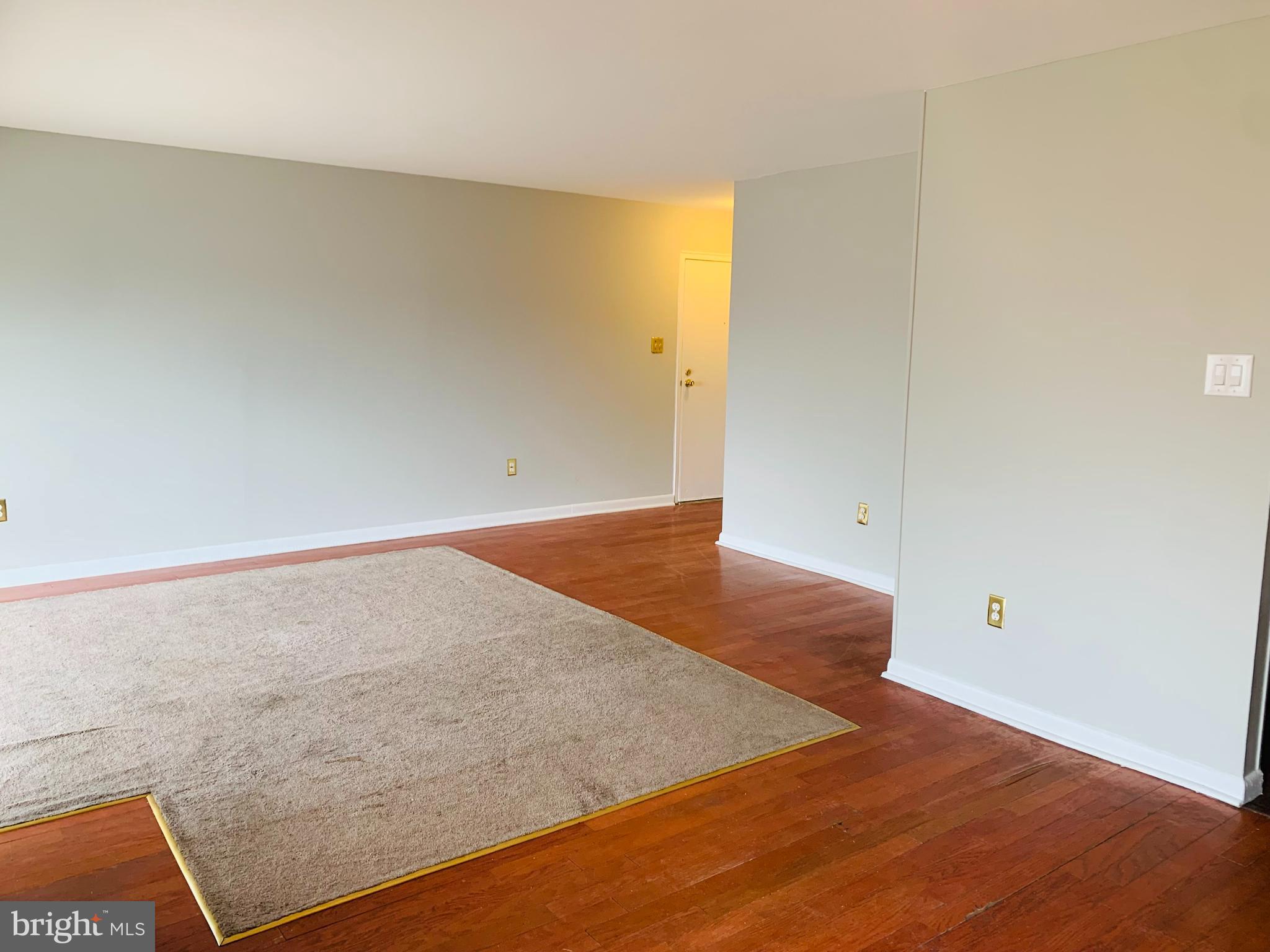 8875 Tamebird Court, Unit J Columbia, MD 21045 - Photo 8 of 15 an empty room with wooden floor