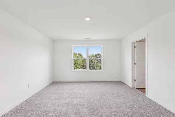 a view of an empty room and a bathroom