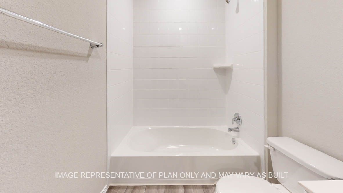 5660 Drake Drive Orange, TX 77632 - Photo 14 of 15 a bathroom with a bathtub and a toilet