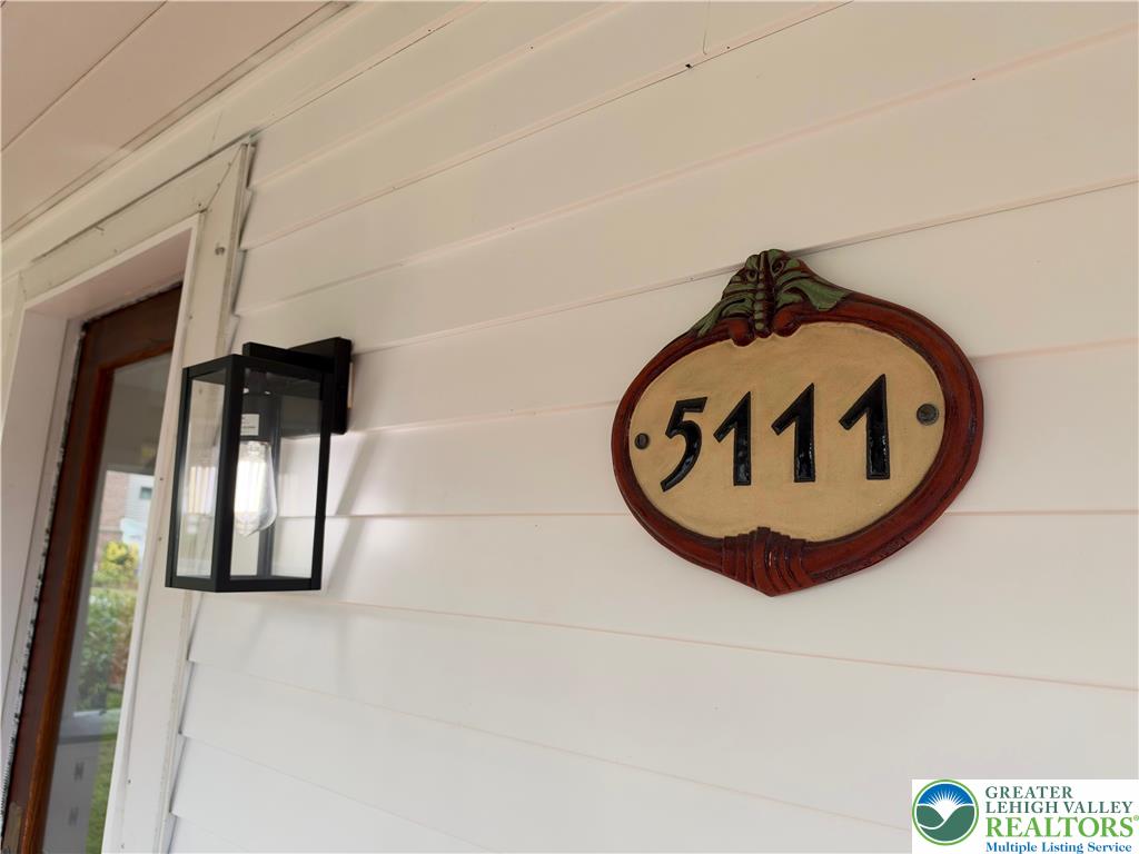 5111 Vera Cruz Road Emmaus, PA 18049 - Photo 7 of 44 Crisp horizontal siding serves as the backdrop for a vintage address plaque and modern lantern.