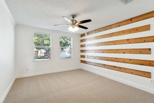 a view of room with window and ceiling fan