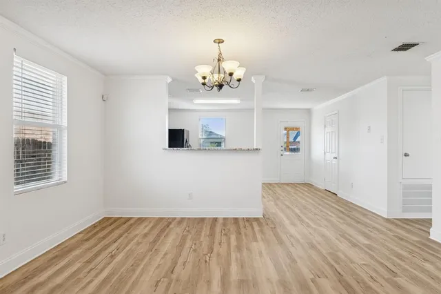 a view of wooden floor and windows in a room