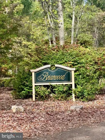 a view of a house with a tree in the background