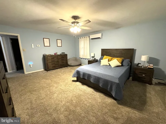 a view of a house with a yard and large tree