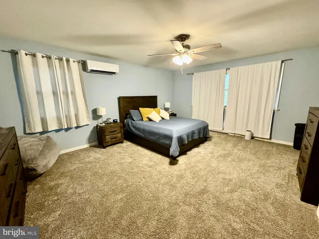 a view of a house with backyard and a tree