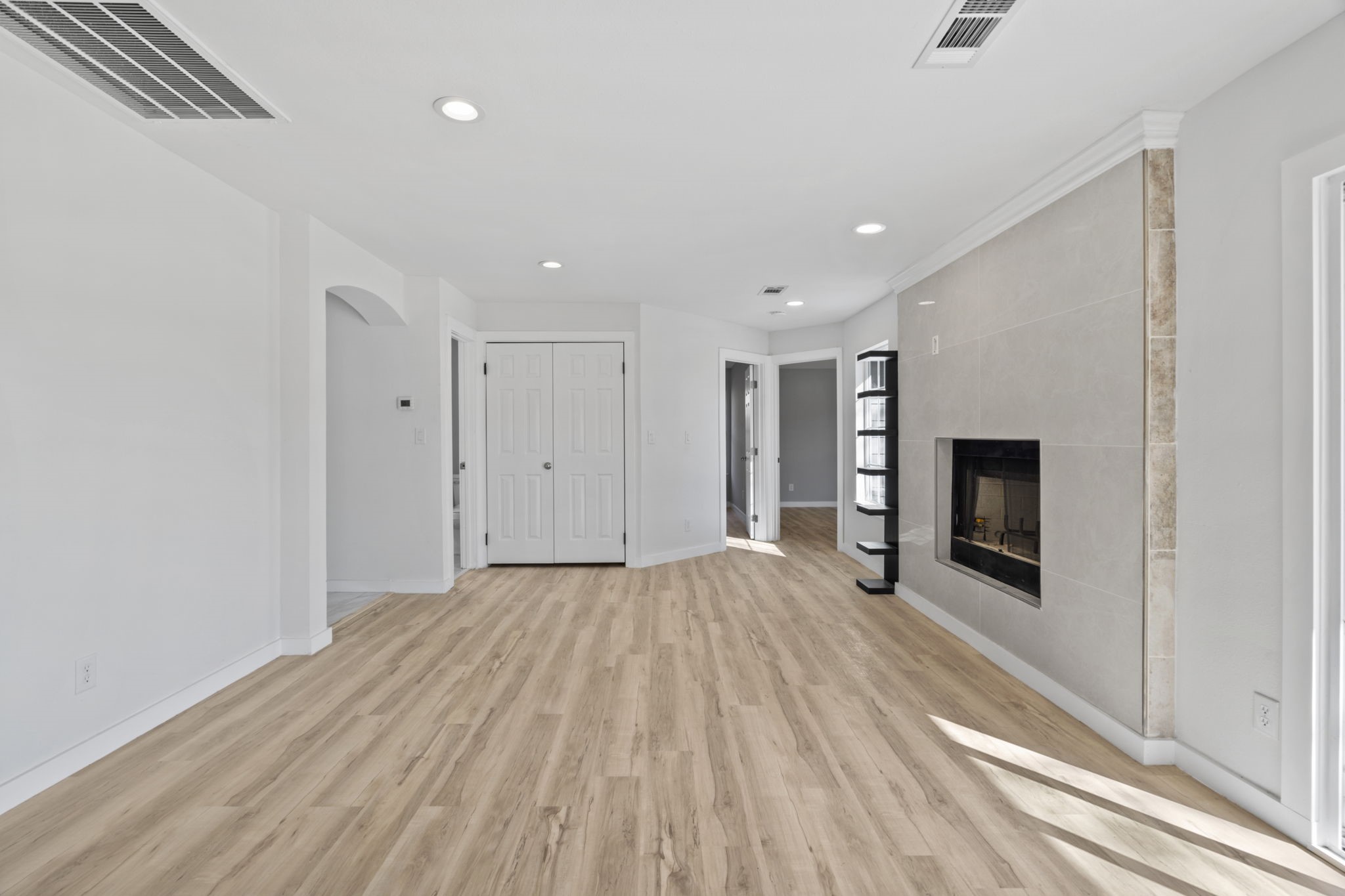 1740 6th Street Hempstead, TX 77445 - Photo 18 of 21 a view of empty room with wooden floor and fireplace