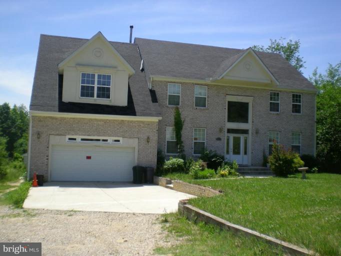 a front view of a house with a yard and a garage