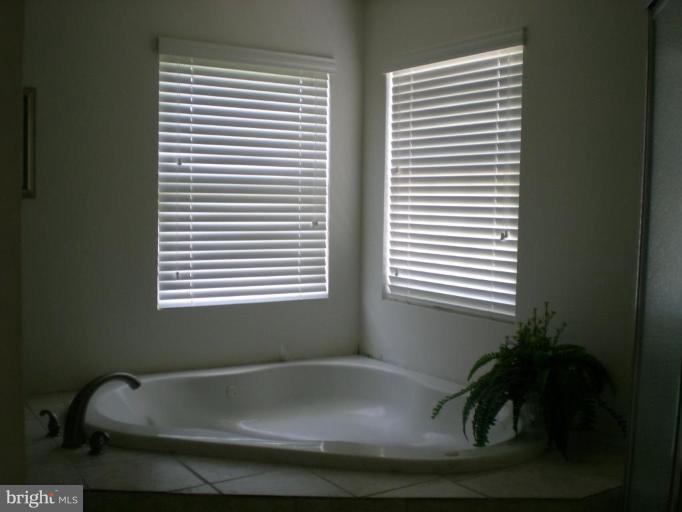 2205 Cool Spring Road Adelphi, MD 20783 - Photo 9 of 9 a bath tub sitting in a bathroom next to a window