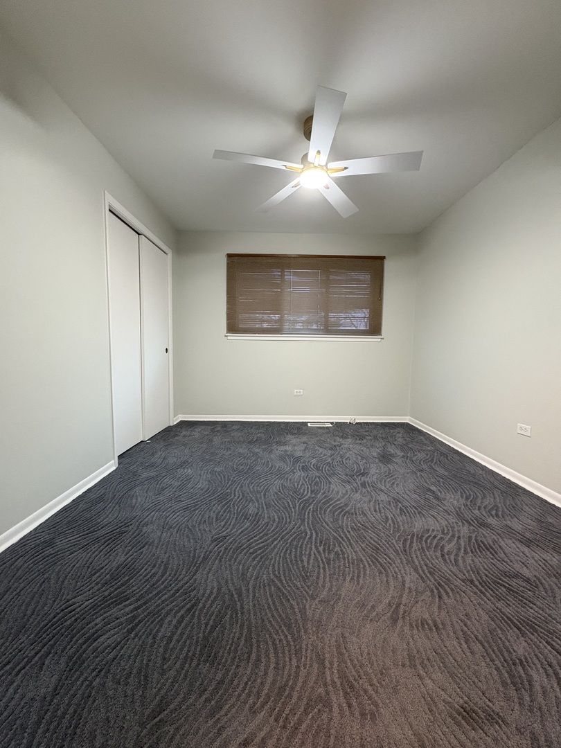 1100 Potter Road Park Ridge, IL 60068 - Photo 23 of 49 an empty room with wooden floor and windows