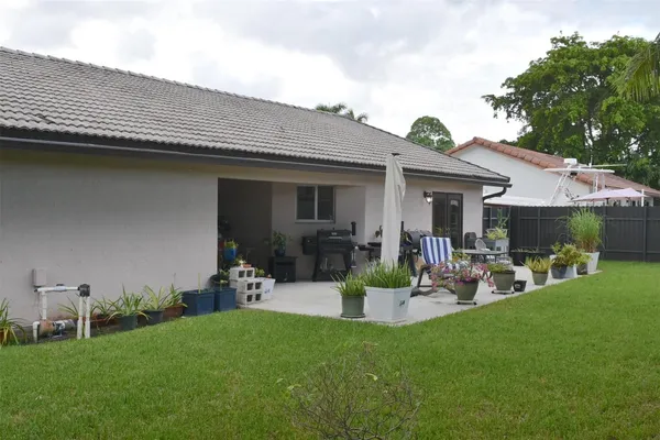 a front view of a house with garden and patio