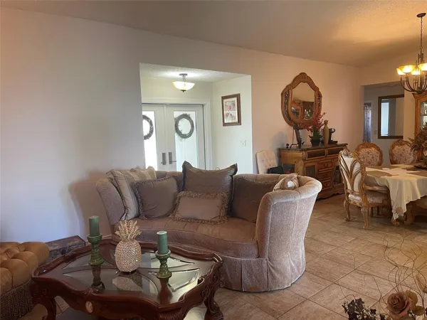 a living room with furniture and a mirror