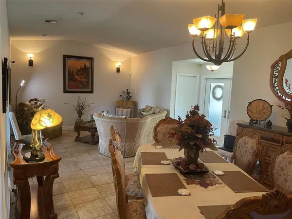 a living room with furniture and chandelier