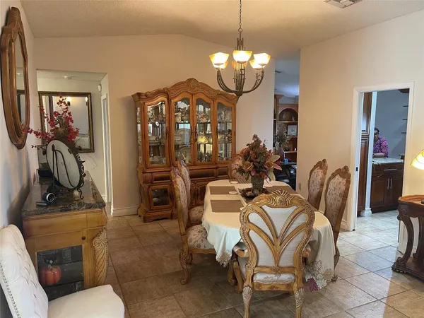 a view of a dining room with furniture and chandelier