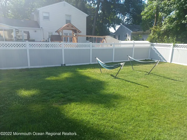 a view of backyard of house with seating space