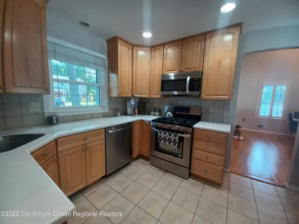 a kitchen with stainless steel appliances granite countertop a stove sink and cabinets