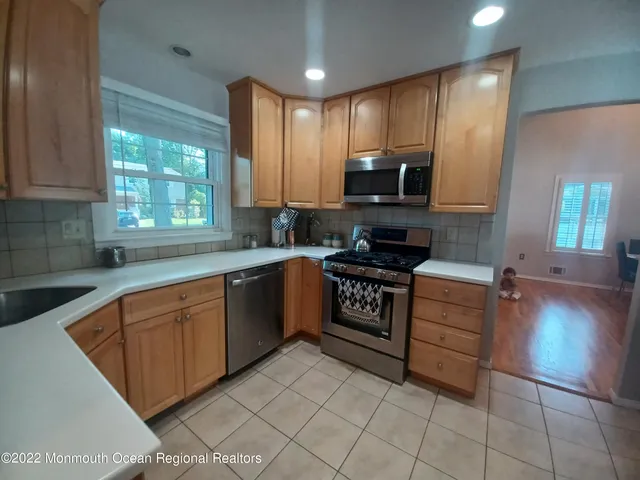 a kitchen with stainless steel appliances granite countertop a stove sink and cabinets