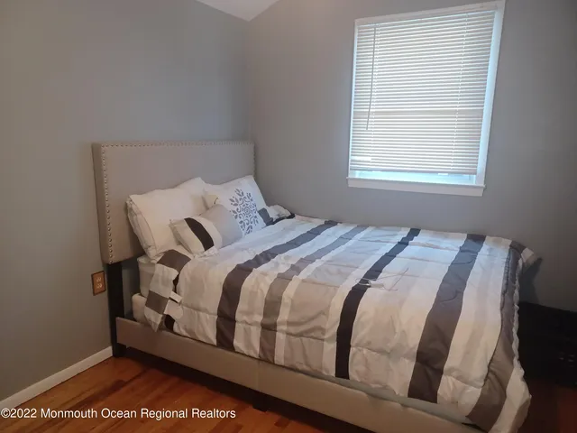 a bed sitting in a bedroom next to a window