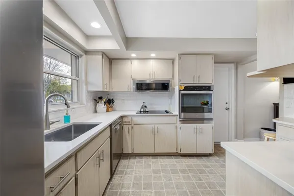 a view of a hallway with wooden floor and a bathroom