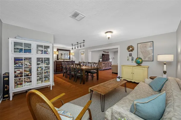a bedroom with a bed wooden floor and view of bathroom