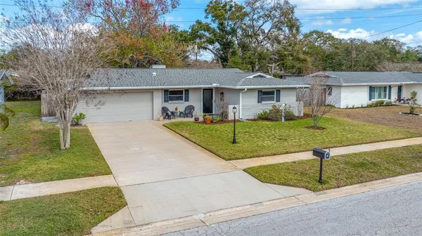 a kitchen with stainless steel appliances a sink a stove a microwave a refrigerator a sink and cabinets