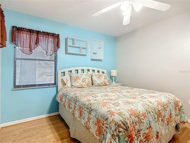 a large bed sitting in a bedroom next to a window