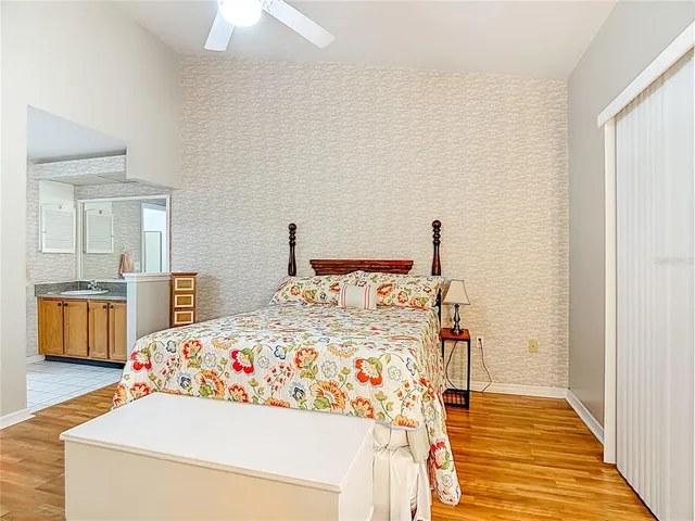 a bedroom with a bed and a chandelier