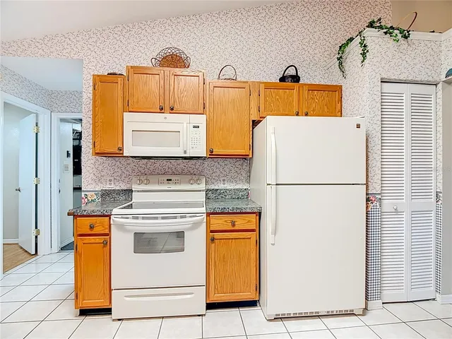 a kitchen with appliances a stove and a refrigerator
