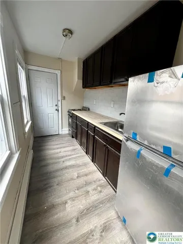 a kitchen with granite countertop a stove and a refrigerator