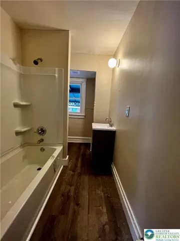 a bathroom with a bathtub and a shower