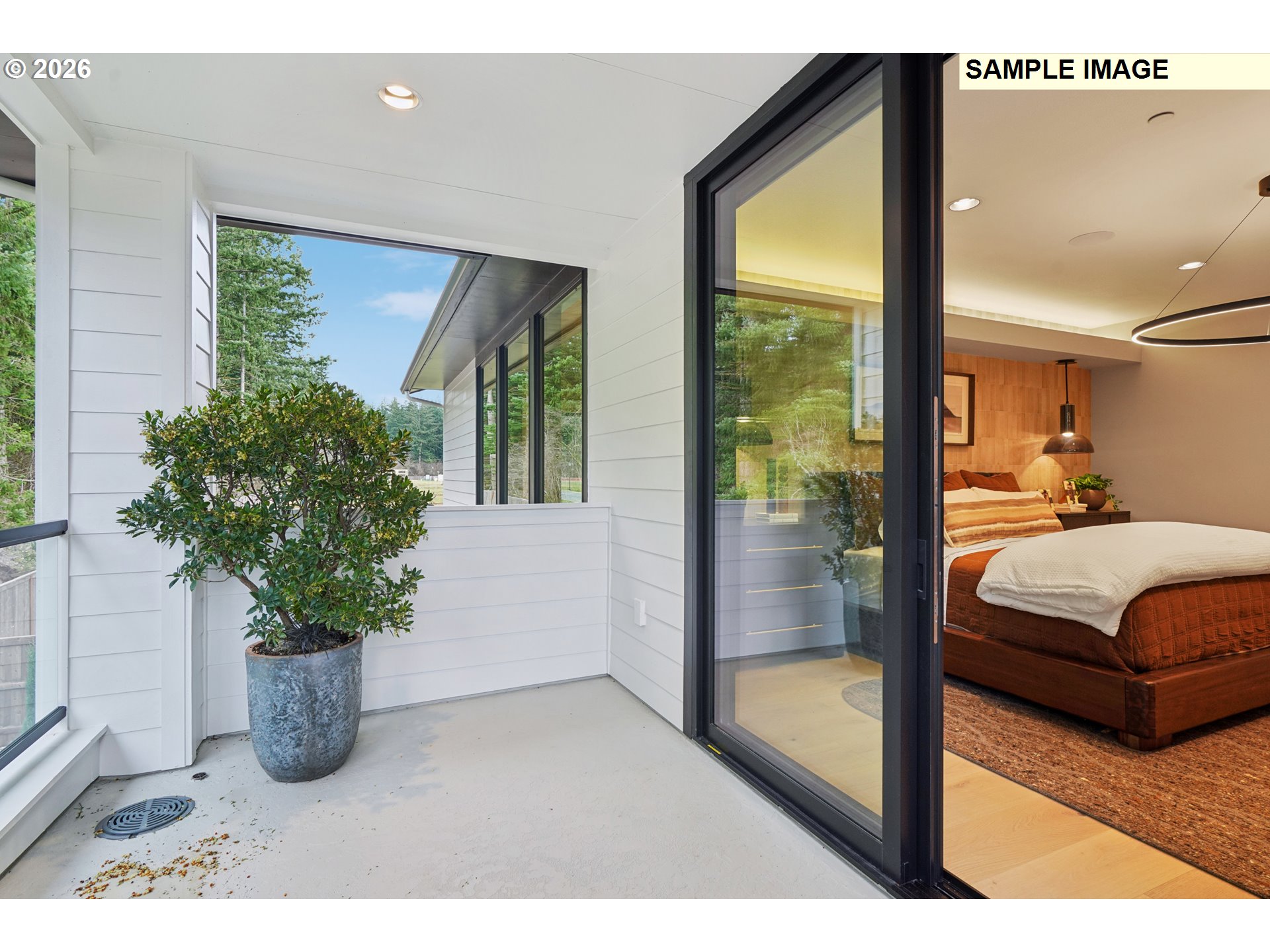 5244 North 94th Avenue Camas, WA 98607 - Photo 11 of 15 a bedroom with a balcony a bed and a potted plant