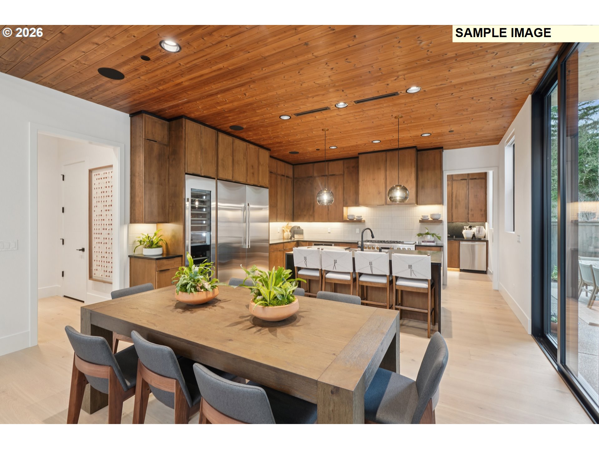 5244 North 94th Avenue Camas, WA 98607 - Photo 6 of 15 a kitchen with stainless steel appliances kitchen island granite countertop a table chairs and a refrigerator