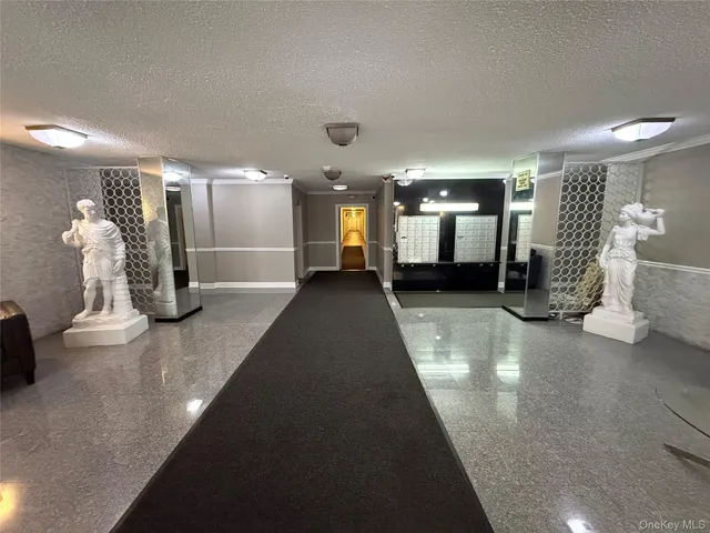 a lobby with furniture and large windows