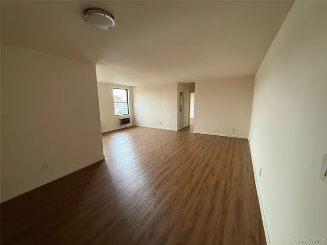 a view of a room with wooden floor