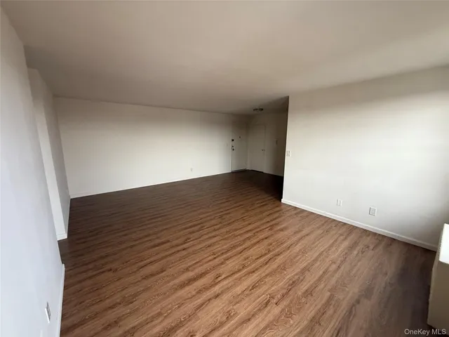 a view of an empty room and wooden floor